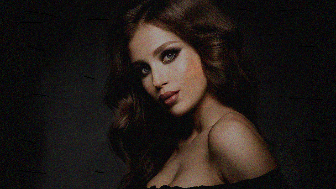 Editorial fashion model in soft dark studio lighting